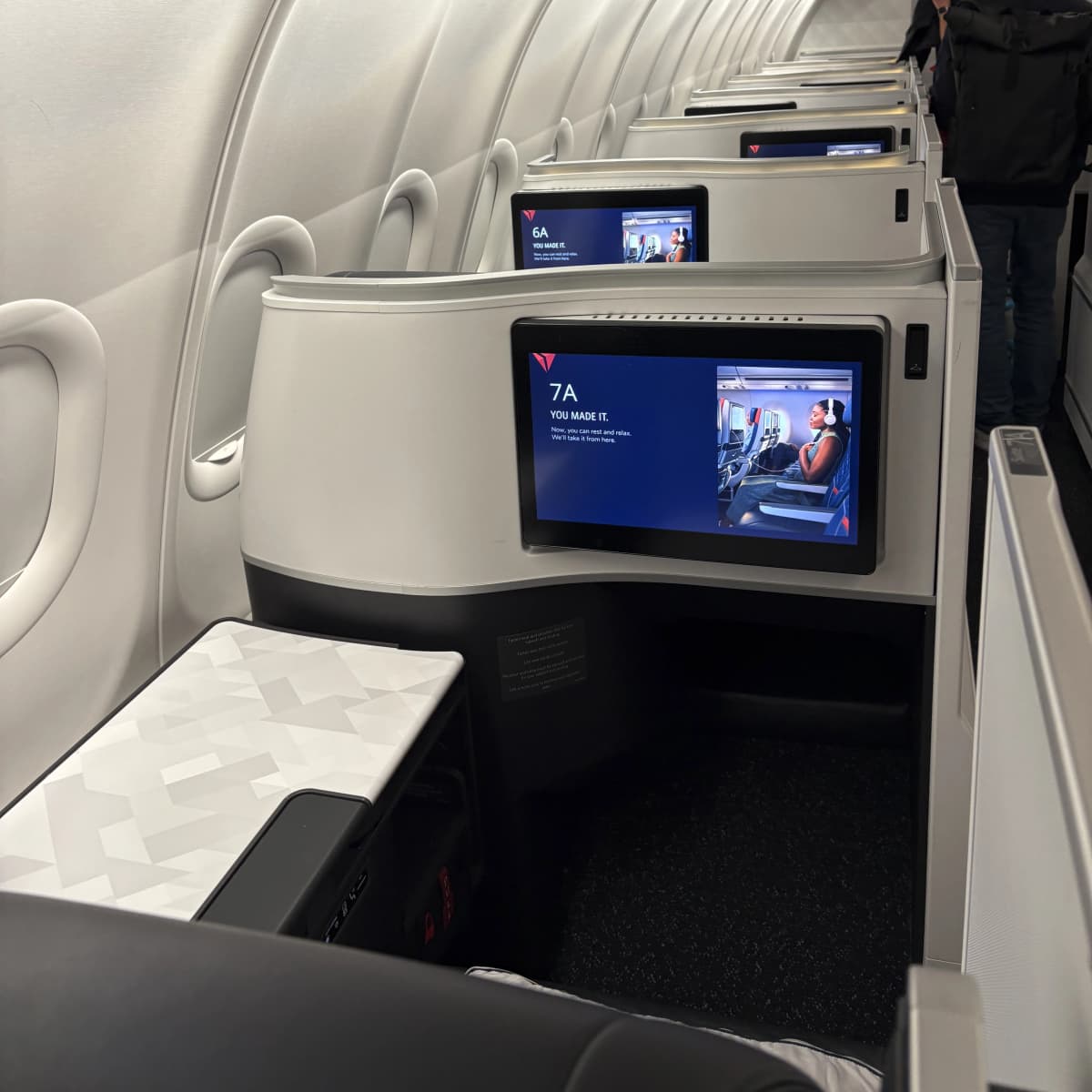 Delta One business class cabin on the Airbus A330 900neo featuring private suites and modern design