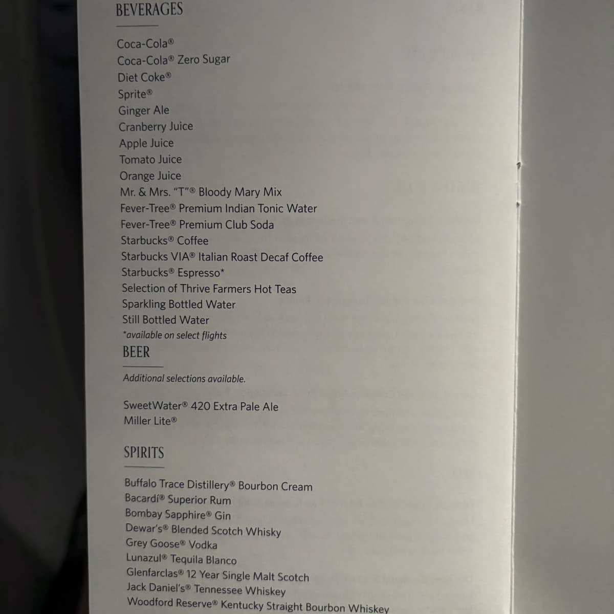 Delta One beverage menu listing cocktails, soft drinks, and coffee options