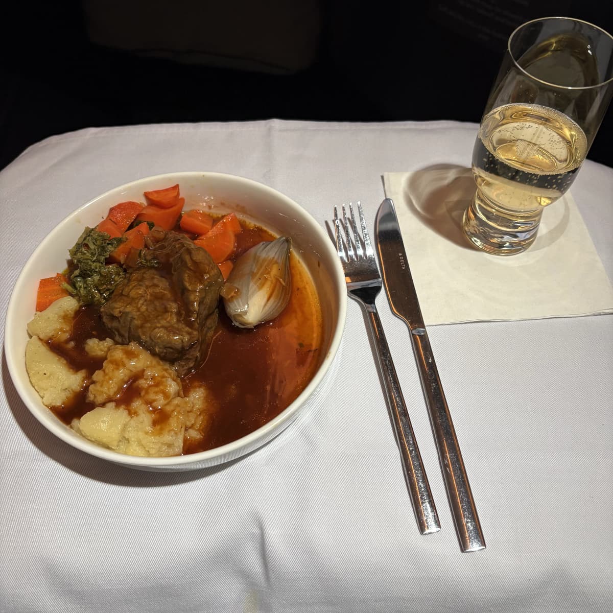 Delta One inflight dinner entree featuring beef short rib and vegetables