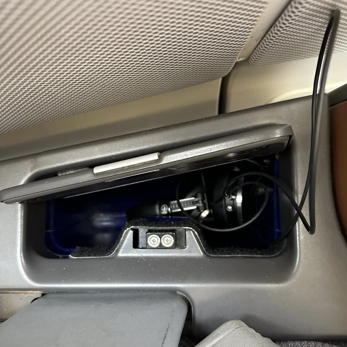 Lufthansa Airlines business class headphone storage cubby.
