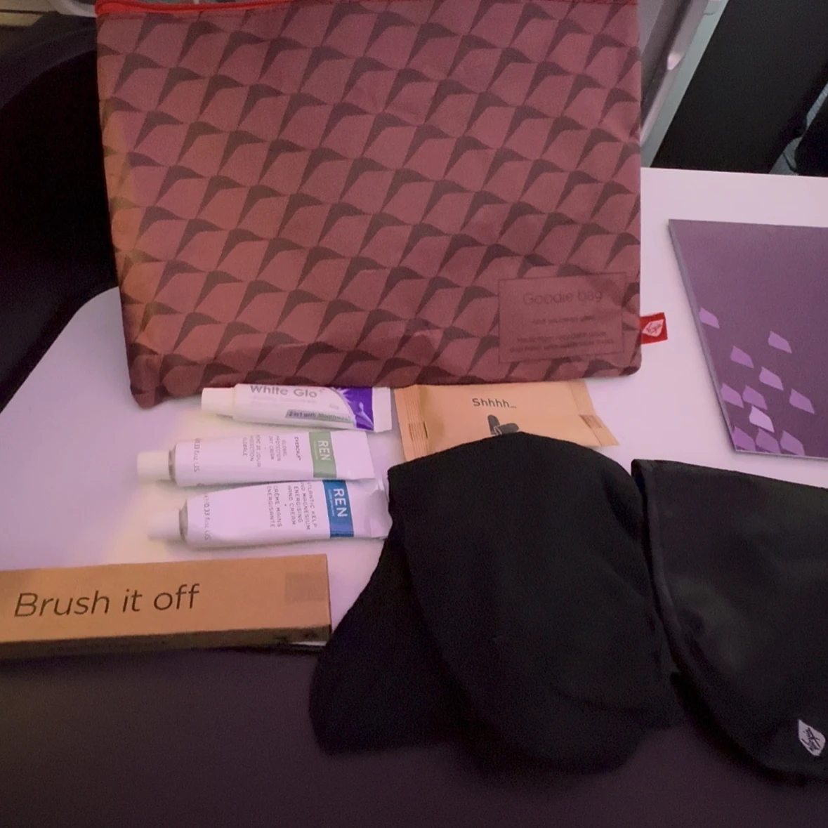Virgin Atlantic Upper Class amenity kit contents including eye mask, earplugs, and toothbrush.