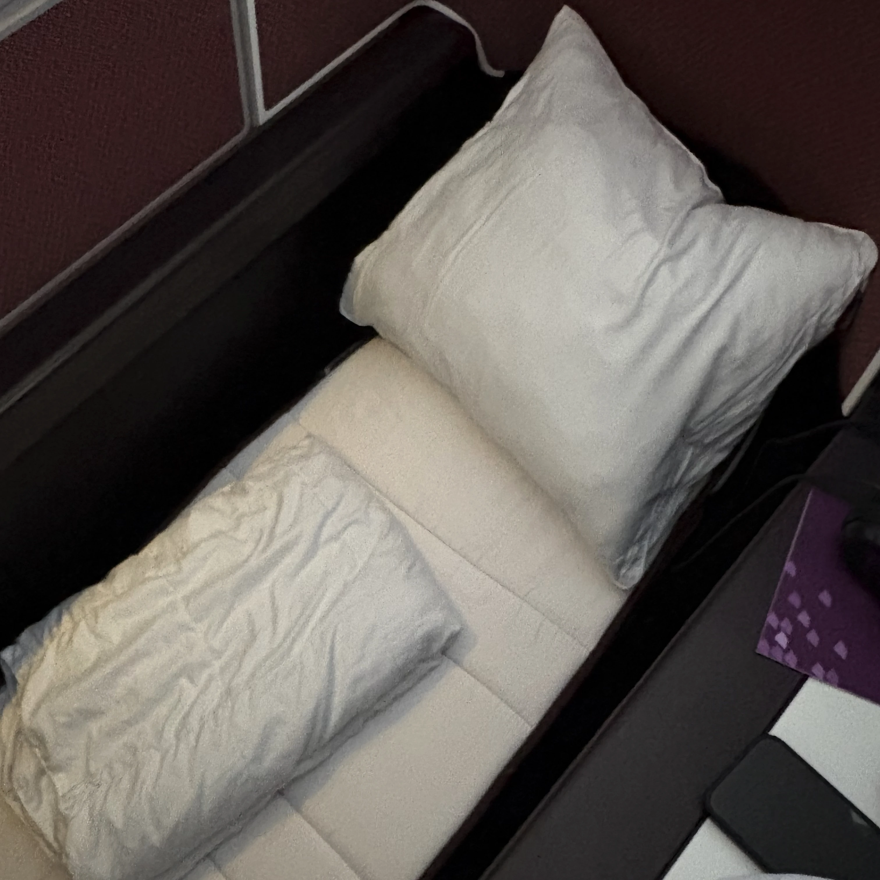 Virgin Atlantic Upper Class bed mode with mattress pad for improved sleep comfort.