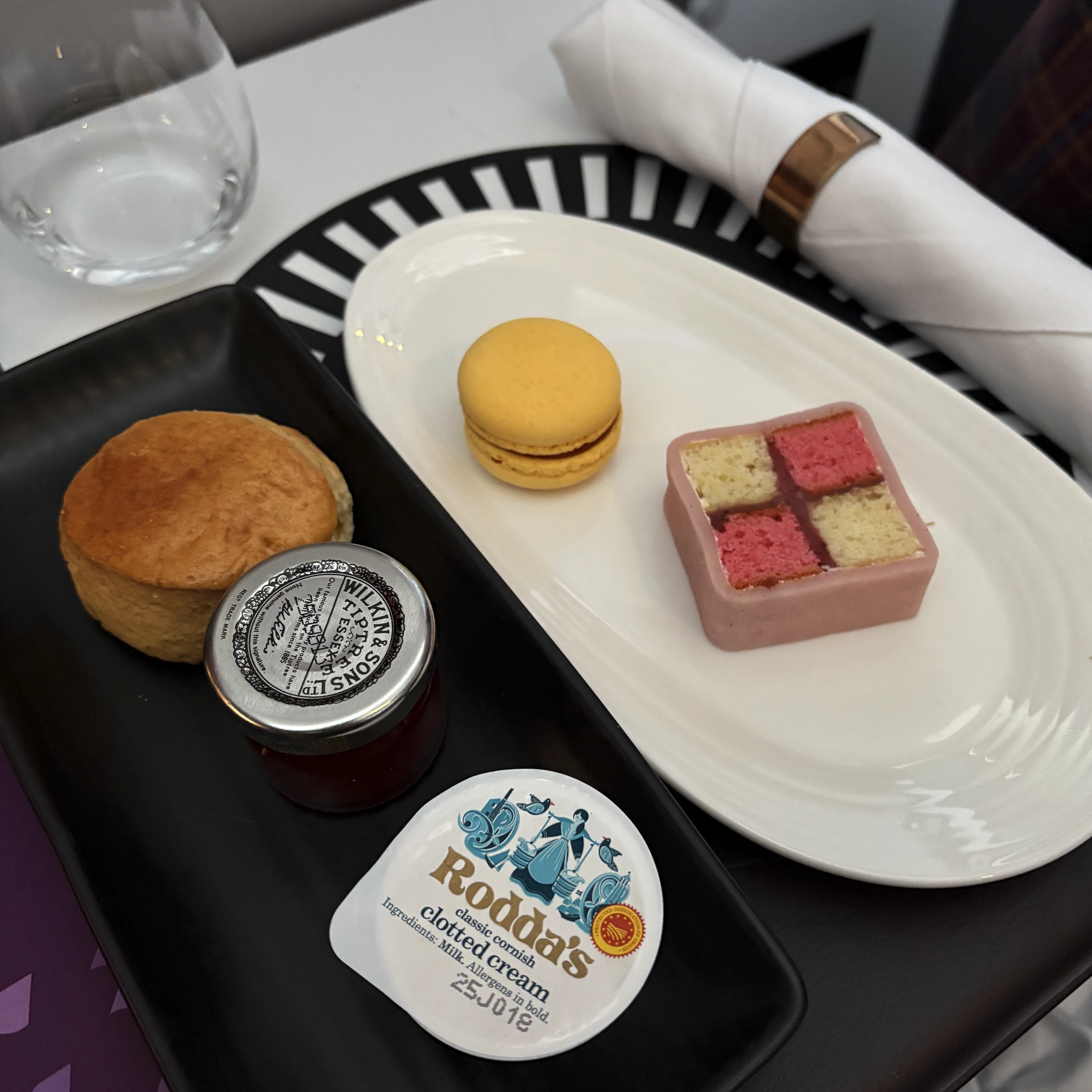 Mile high tea service in Virgin Atlantic Upper Class featuring biscuits with clotted cream and jam.